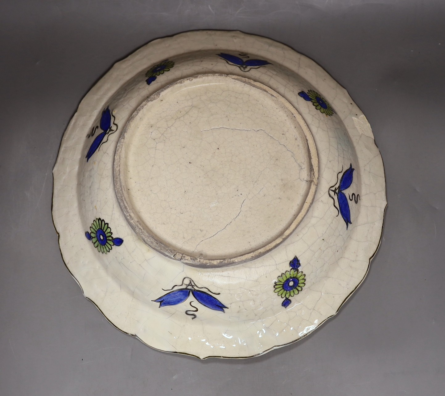 A large Persian fritware charger, in Iznik style, 36cm